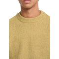 Primer plano del cuello redondo del jersey Volcom Edmonder II en color mostaza, con detalle del punto ribeteado y el hombro raglán visible en la costura.