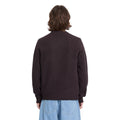 Vista trasera de hombre con jersey Volcom Edmonder II en color pasa, mostrando el ajuste en la espalda y las mangas largas del tejido de punto grueso y jaspeado.