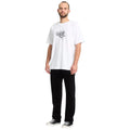 Modelo con camiseta blanca y el pantalón Volcom Solver 5 Pocket Cord en color negro de cuerpo entero, vista frontal en ángulo mostrando el corte de pierna recta.