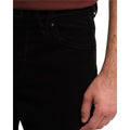 Detalle en primer plano del bolsillo delantero del pantalón Volcom Solver 5 Pocket Cord en color negro, mostrando la textura acanalada de la pana y las costuras.