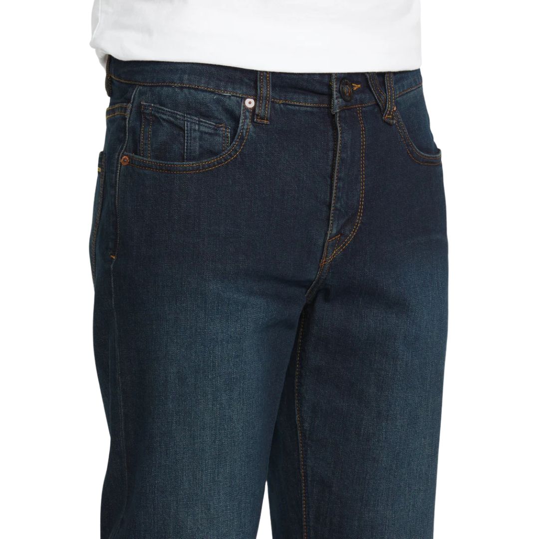 Detalle del bolsillo delantero del pantalón vaquero Volcom Solver Denim color New Washed Blue con remaches metálicos y costuras visibles.