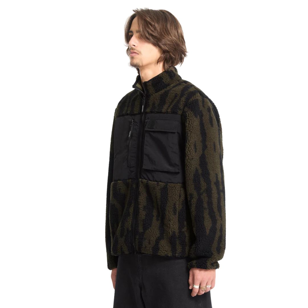 Vista lateral de la chaqueta Volcom Storm Stone Zip verde y camuflaje.